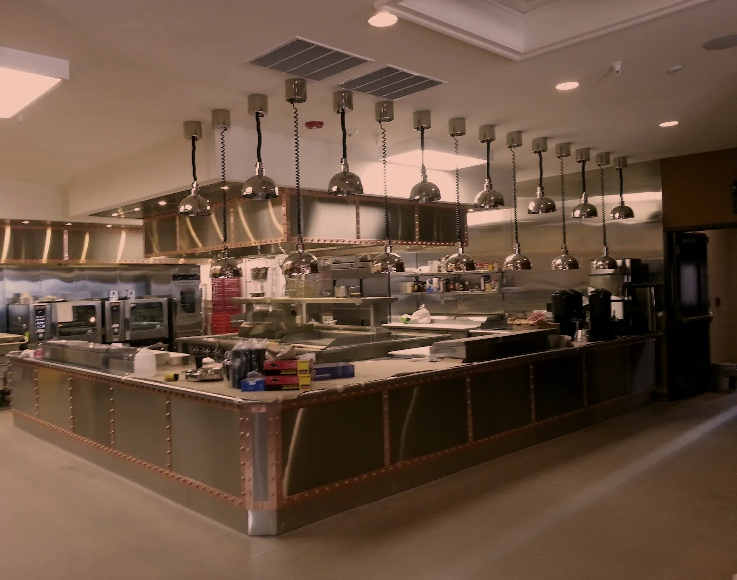 Custom stainless steel cook island with copper trim and heat lamps in a commercial kitchen, fabricated by O'Donnell Metal Fab in Norristown PA