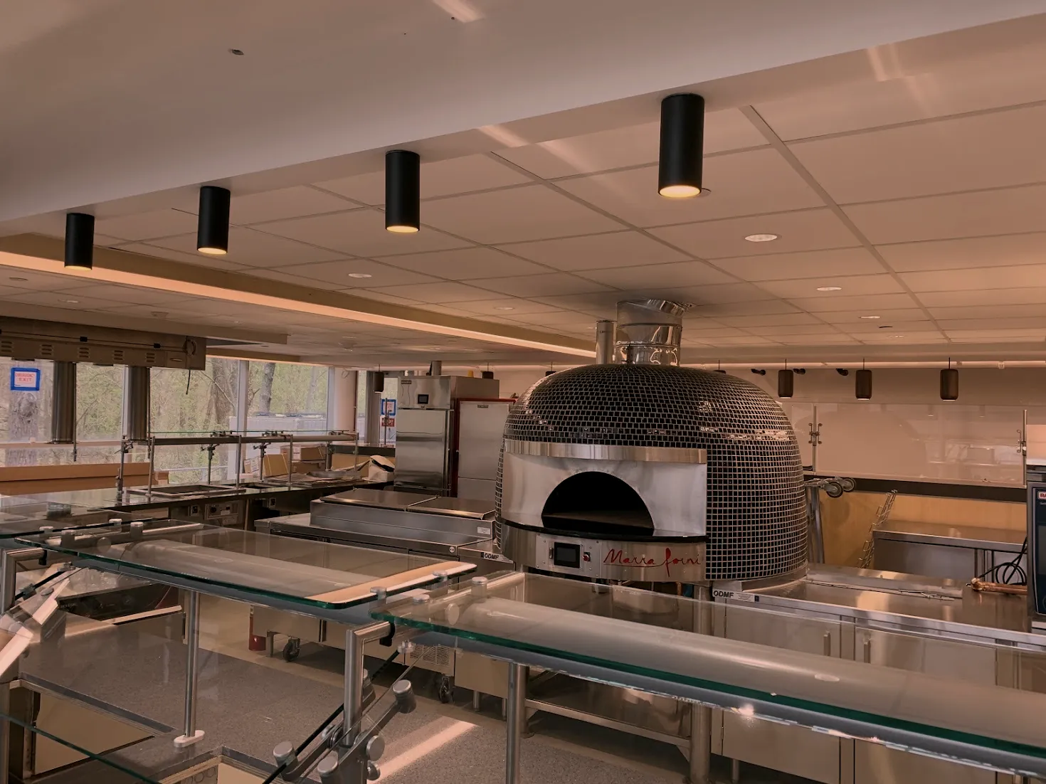 Pizza oven station with a custom stainless steel ODMF base and prep tables, commercial kitchen fabrication