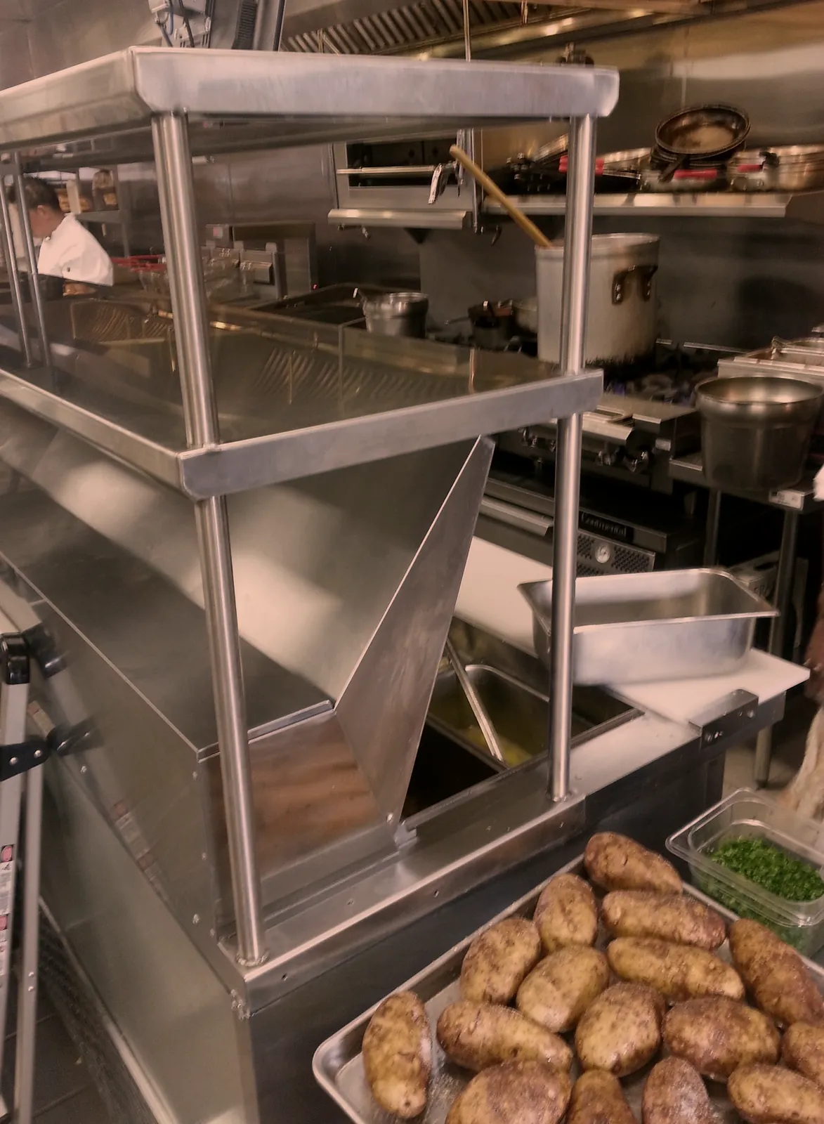 Stainless steel overshelf fabricated over a restaurant cook line, commercial kitchen shelving by O'Donnell Metal Fab