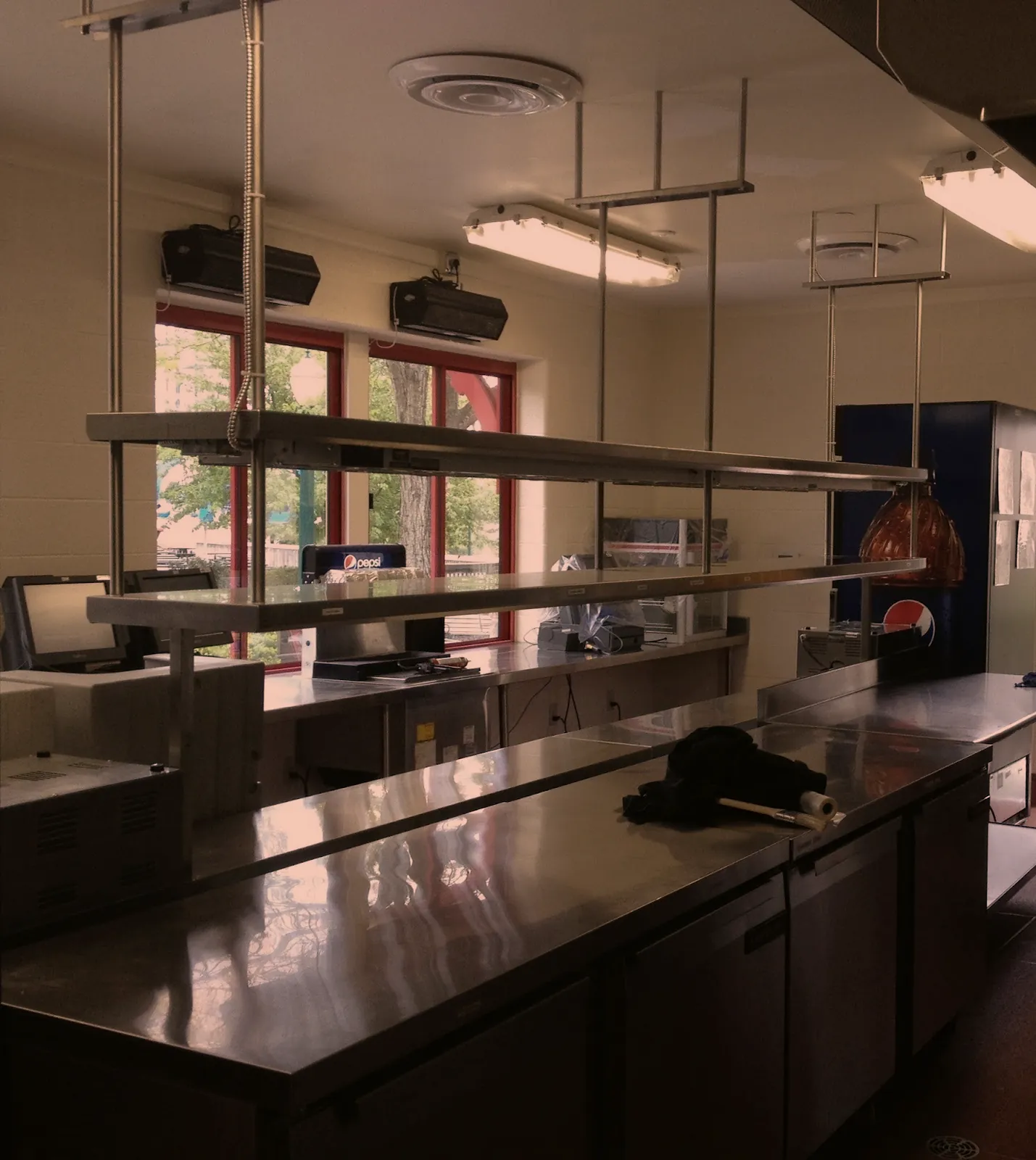 Hanging stainless steel overshelves above a prep line, commercial kitchen fabrication in Norristown PA