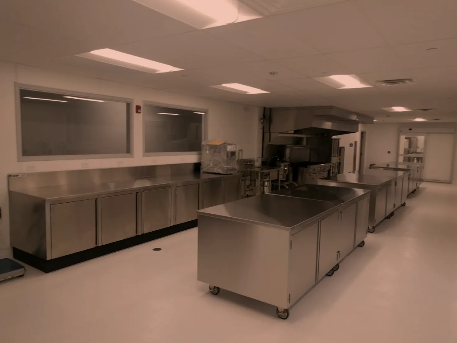 Stainless steel base cabinets and mobile islands in a teaching kitchen, fabricated by O'Donnell Metal Fab