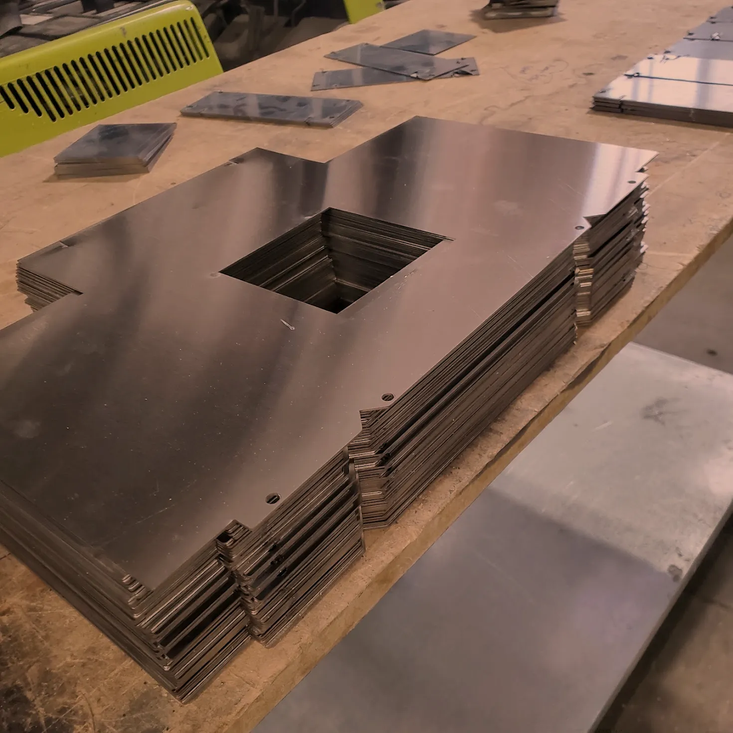 Stacked laser cut cover plates ready for the next operation, contract metal fabrication in Norristown PA