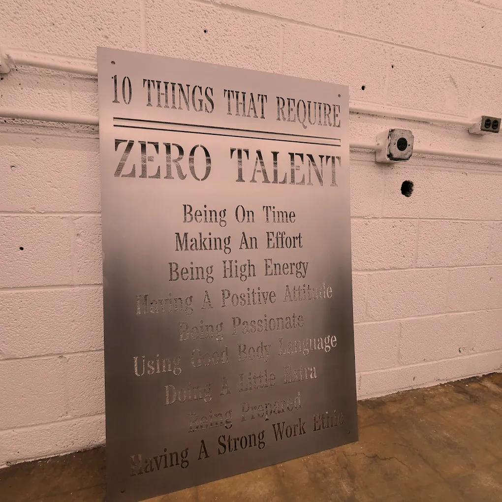 Steel sign with laser cut lettering leaning on the O'Donnell Metal Fab shop wall in Norristown PA