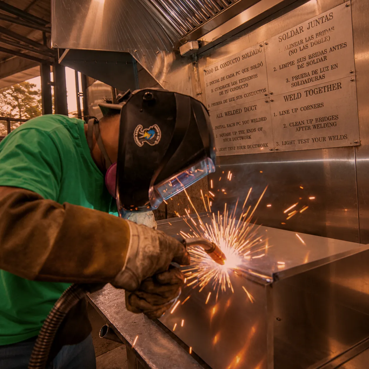 O'Donnell Metal Fab welder MIG welding ductwork beneath the welding procedures sign, welding service in Norristown PA