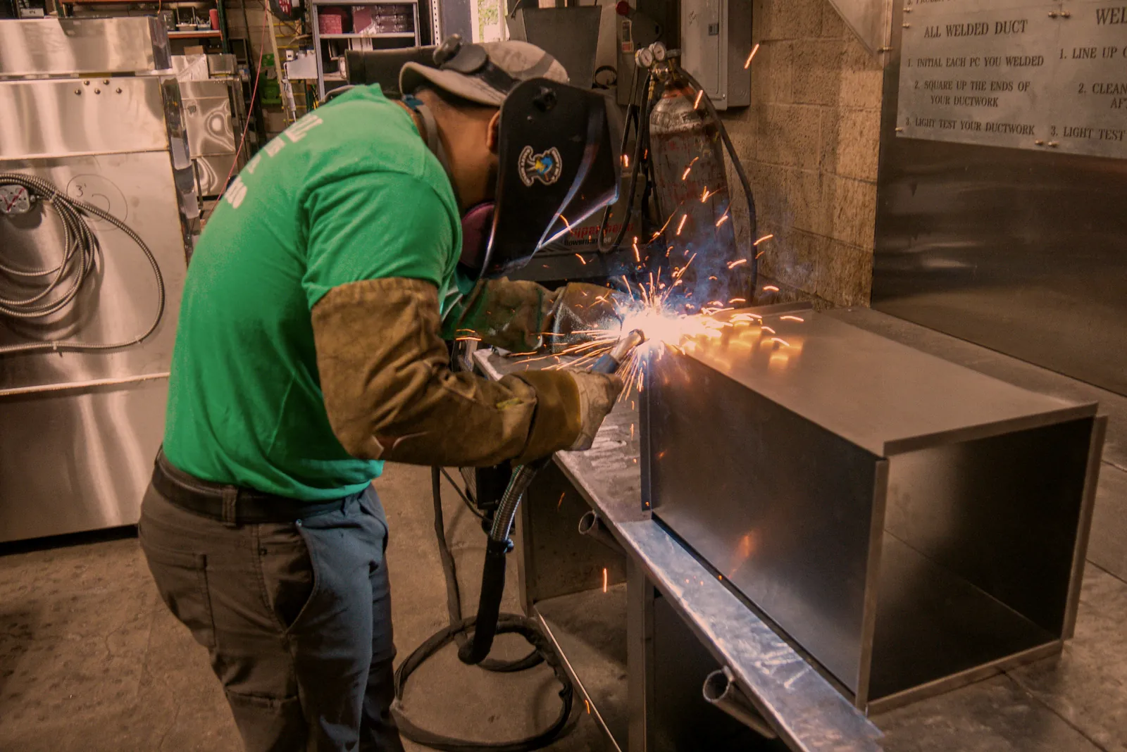 O'Donnell Metal Fab welder MIG welding a sheet metal duct section in the Norristown PA shop