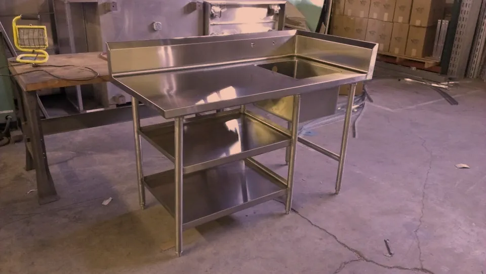 Stainless steel sink table with undershelves on the O'Donnell Metal Fab shop floor before delivery, Norristown PA