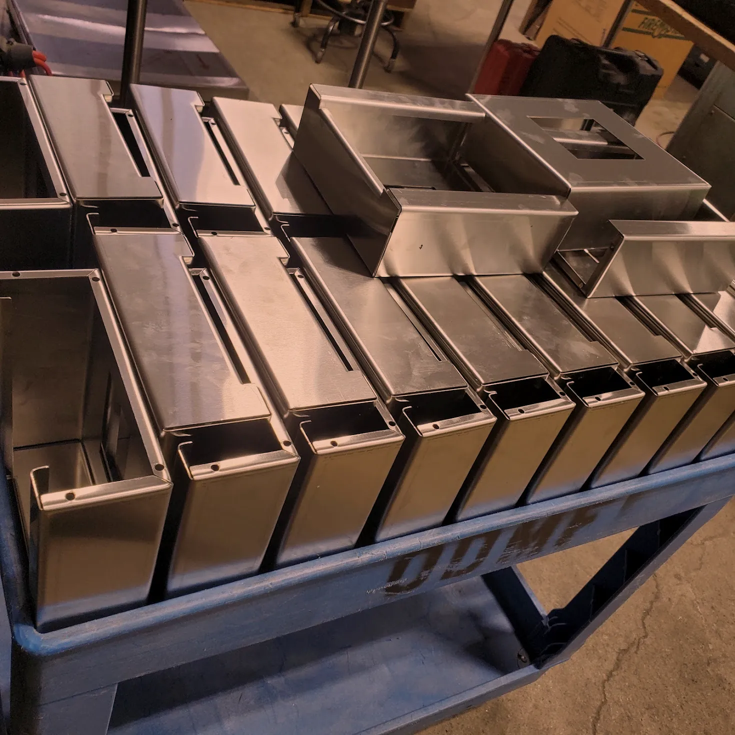 Formed stainless steel enclosure bodies lined up on an ODMF cart, metal enclosure fabrication at O'Donnell Metal Fab in Norristown PA