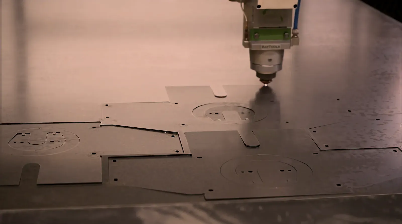 Laser cut steel brackets with holes and slots still in the sheet, plus or minus .005 inch laser capability at O'Donnell Metal Fab